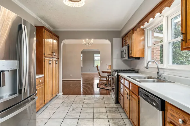 a kitchen with stainless steel appliances granite countertop a refrigerator and a sink