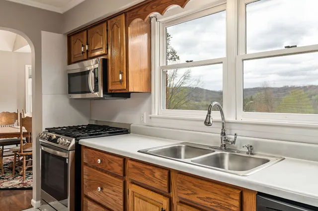 a kitchen with granite countertop a sink and a window