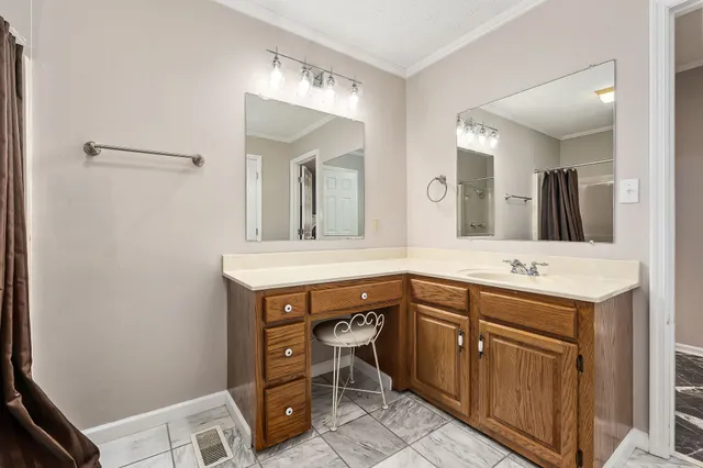 a spacious bathroom with a sink vanity and mirror