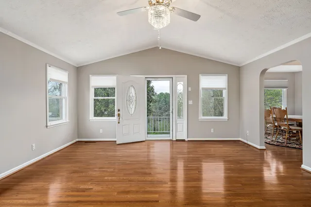 a view of livingroom with furniture wooden floor and front door