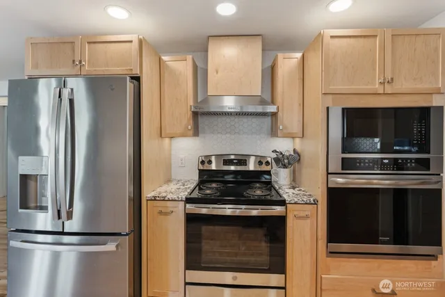 a kitchen with cabinets and stainless steel appliances