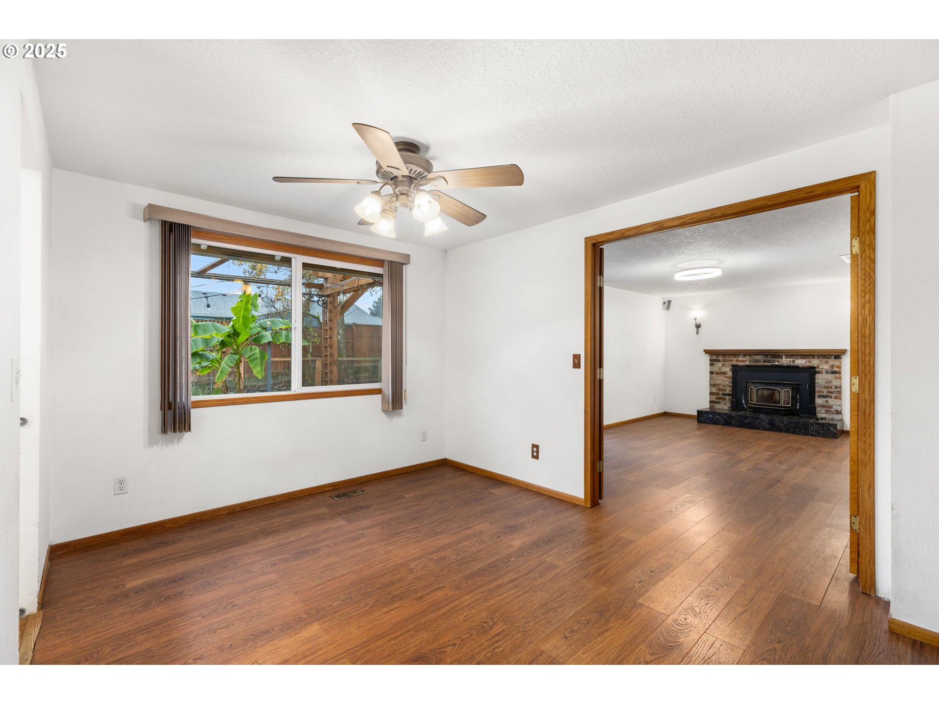 17130 Southwest Baker Street Beaverton, OR 97007 - Photo 14 of 37 a view of empty room with wooden floor and fan