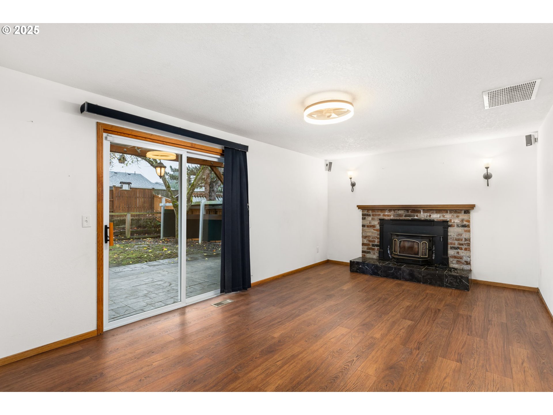 17130 Southwest Baker Street Beaverton, OR 97007 - Photo 15 of 37 a view of an empty room with wooden floor and a window