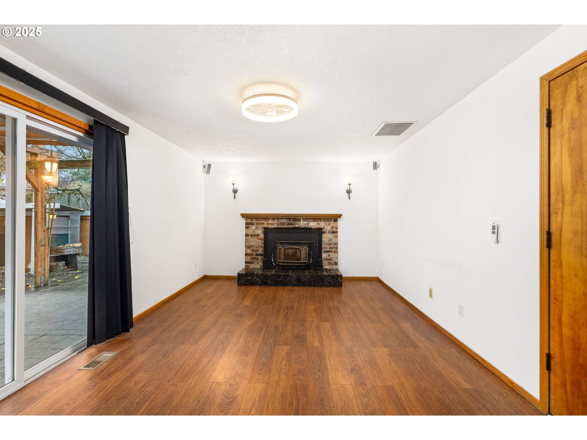 17130 Southwest Baker Street Beaverton, OR 97007 - Photo 16 of 37 a view of empty room with wooden floor and fireplace