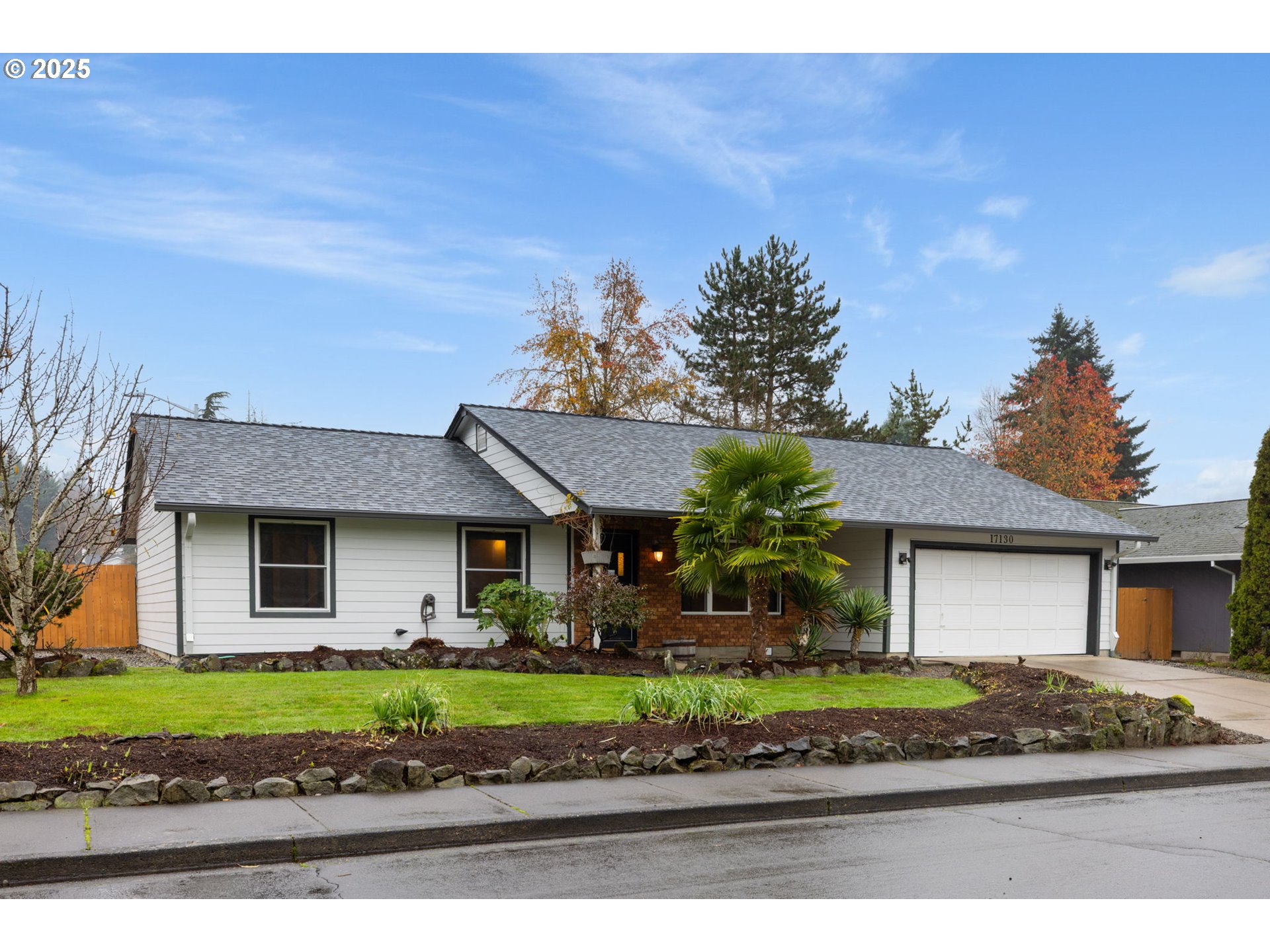 17130 Southwest Baker Street Beaverton, OR 97007 - Photo 2 of 37 a front view of a house with a garden