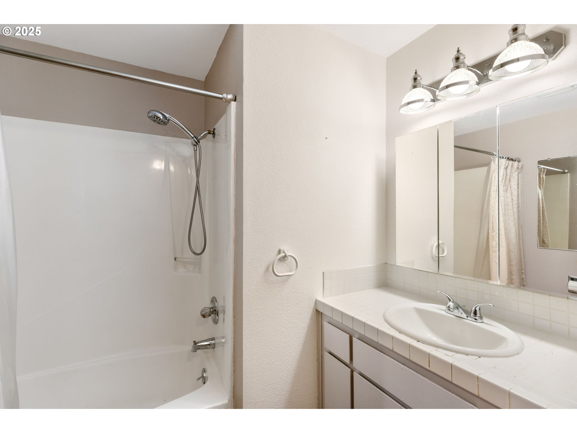 17130 Southwest Baker Street Beaverton, OR 97007 - Photo 27 of 37 a bathroom with a double vanity sink mirror and shower