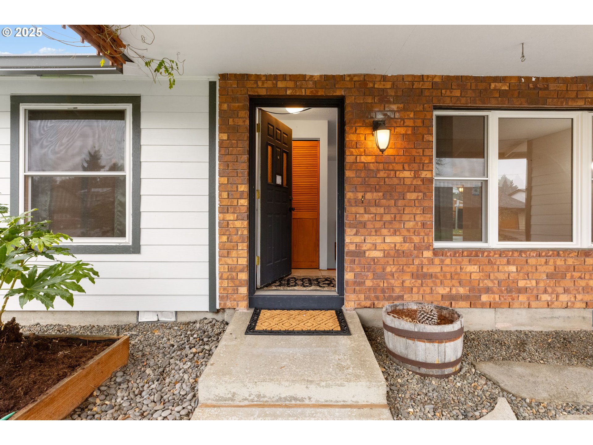 17130 Southwest Baker Street Beaverton, OR 97007 - Photo 6 of 37 a view of a brick house with potted plants
