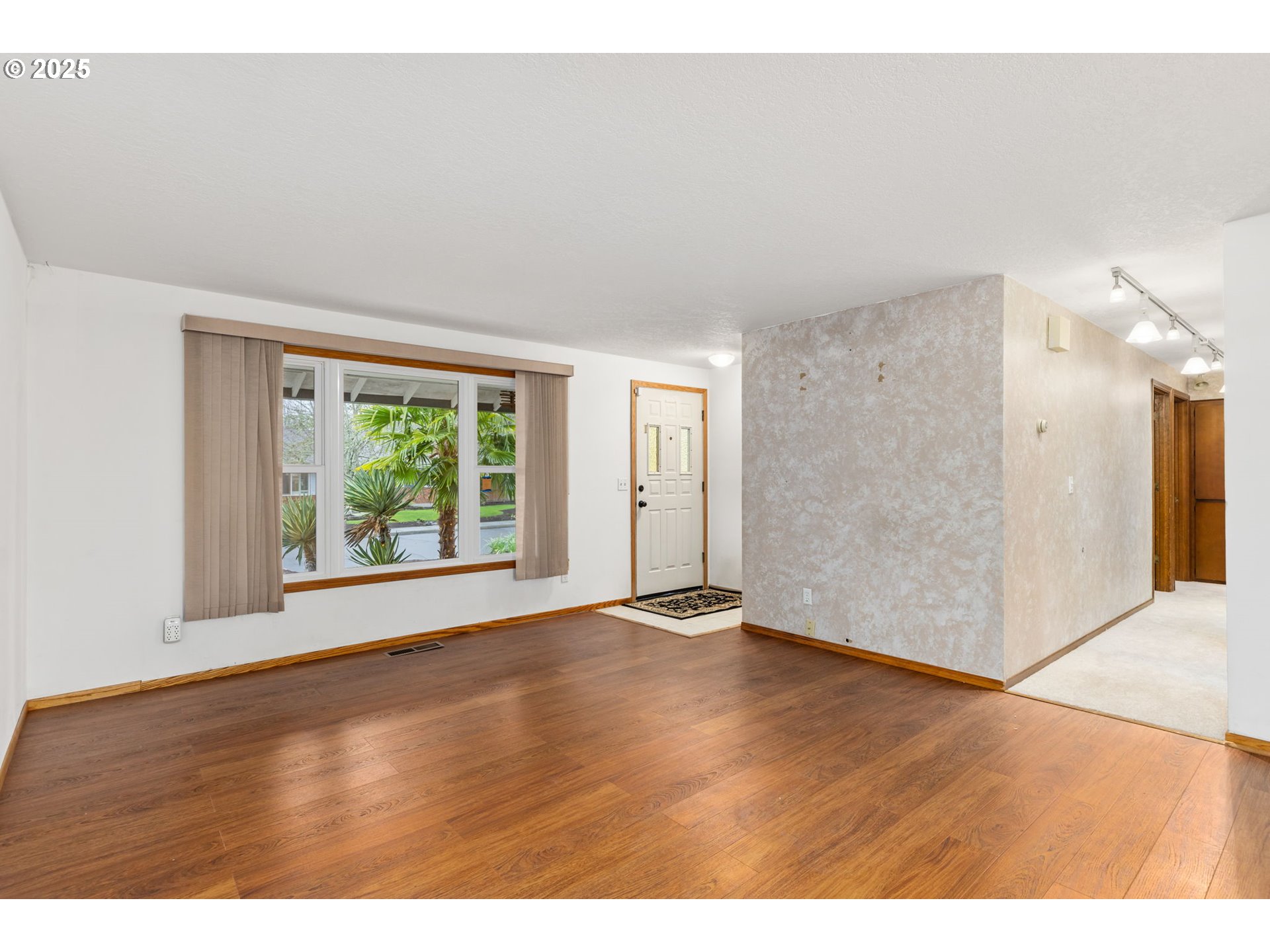 17130 Southwest Baker Street Beaverton, OR 97007 - Photo 7 of 37 a view of an empty room with wooden floor and a window