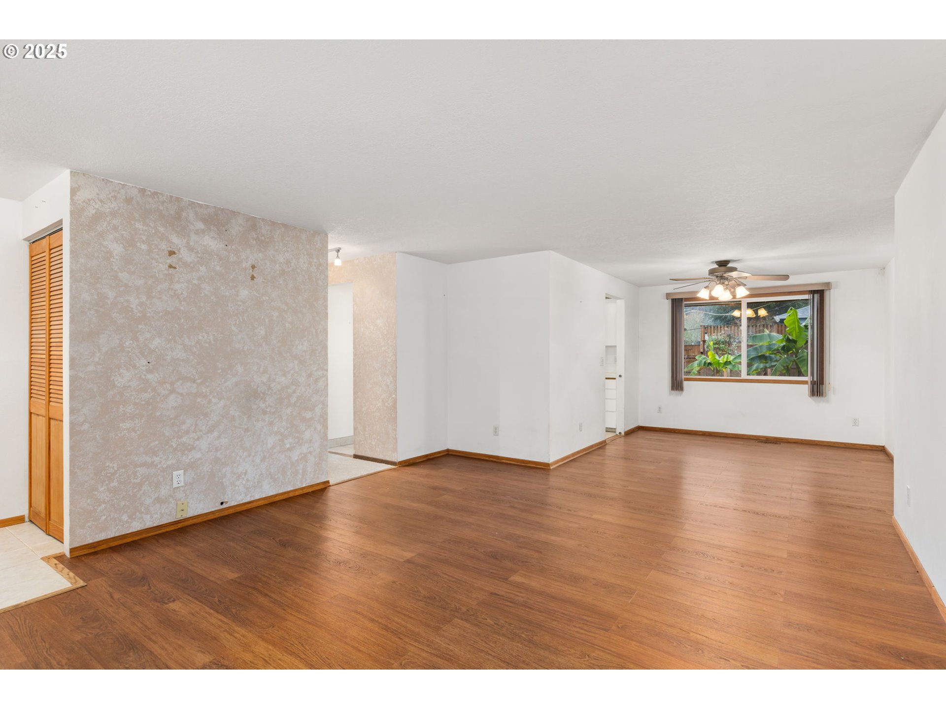 17130 Southwest Baker Street Beaverton, OR 97007 - Photo 10 of 37 a view of an empty room with a window and wooden floor