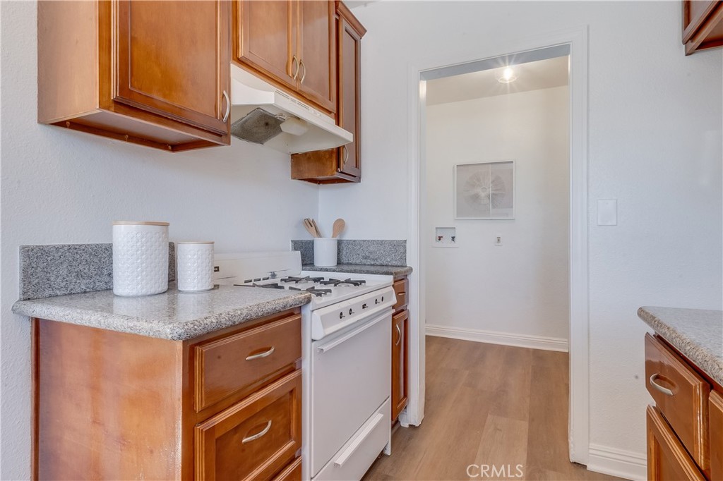 1347 East Bennett Street Compton, CA 90221 - Photo 13 of 31 a kitchen with stainless steel appliances granite countertop a stove and a microwave