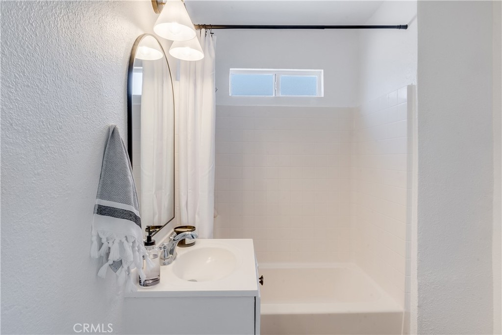 1347 East Bennett Street Compton, CA 90221 - Photo 17 of 31 a bathroom with a bathtub and a sink