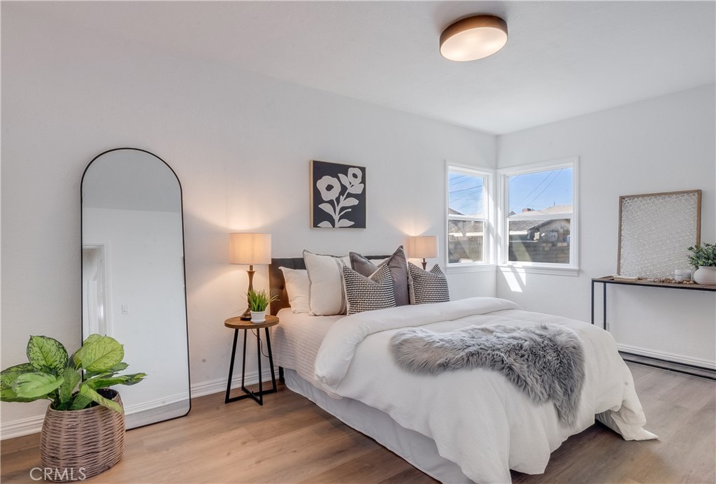 1347 East Bennett Street Compton, CA 90221 - Photo 4 of 31 a bedroom with bed and a potted plant