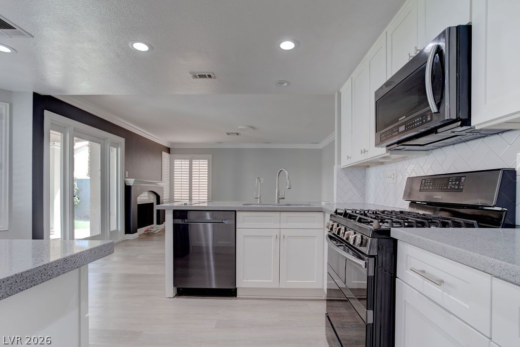 1416 Walstone Road North Las Vegas, NV 89031 - Photo 10 of 47 A well-appointed kitchen features a central island, new appliances, and bright cabinetry, offering both style and utility.