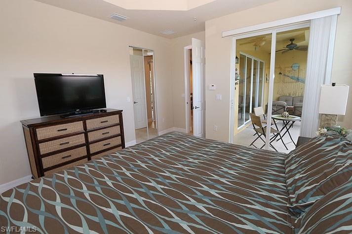 6525 Monterey Point, Unit 203 Naples, FL 34105 - Photo 11 of 25 a bedroom with a bed and flat screen tv