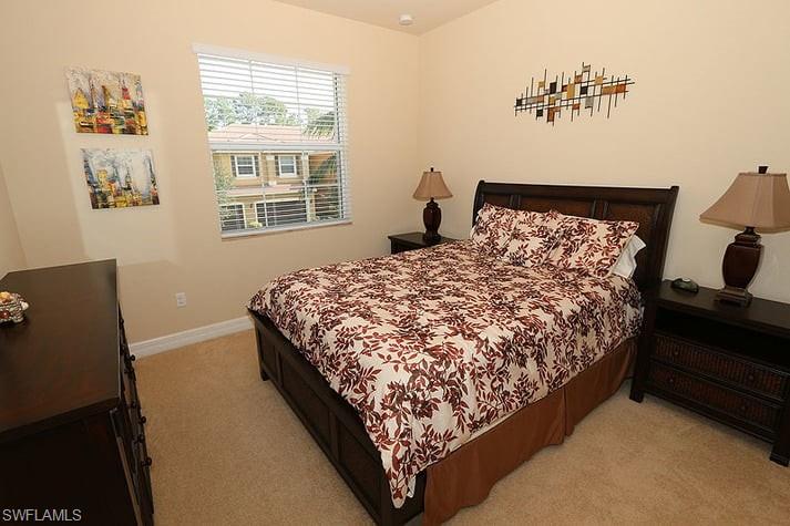 6525 Monterey Point, Unit 203 Naples, FL 34105 - Photo 15 of 25 a bed sitting in a bedroom next to a window
