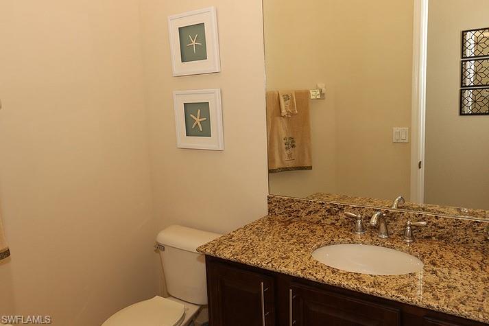 6525 Monterey Point, Unit 203 Naples, FL 34105 - Photo 17 of 25 a bathroom with a granite countertop sink and a mirror