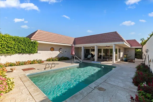 a front view of a house with patio and garden