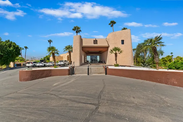 a living room with lots of furniture and a chandelier