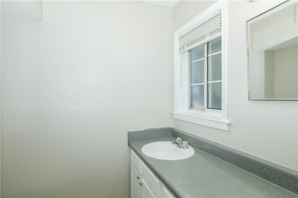 2065 Alison Court Southwest, Unit 6 Atlanta, GA 30311 - Photo 12 of 14 a bathroom with a sink and a mirror