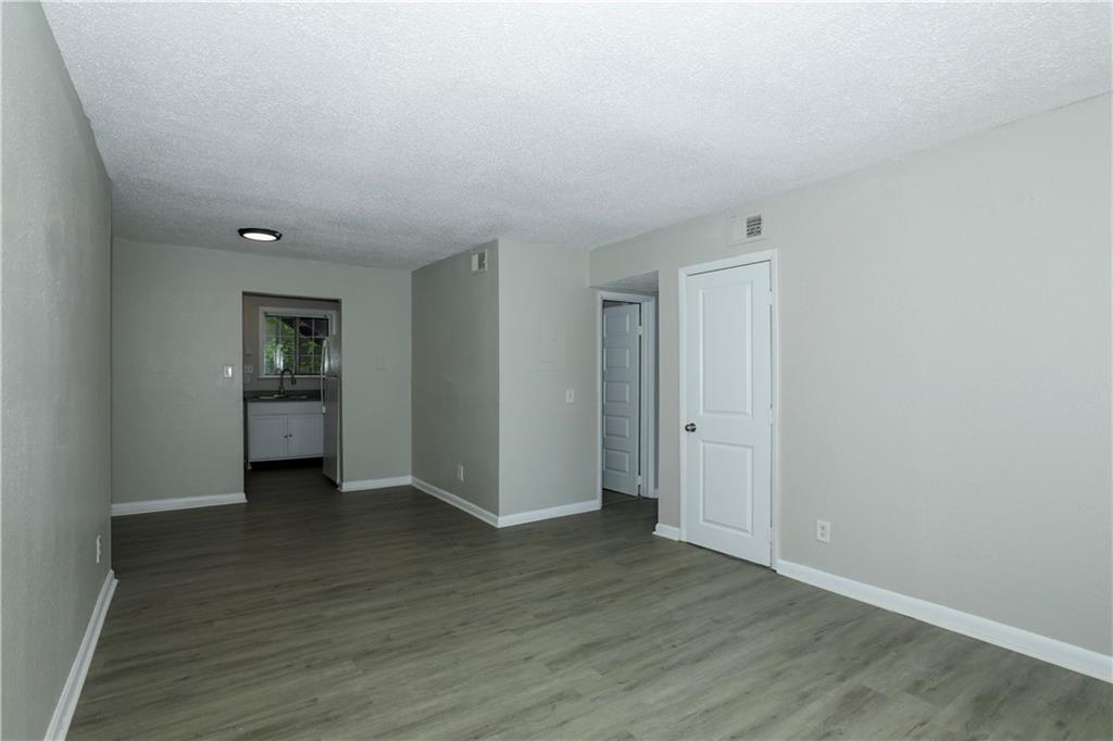 2065 Alison Court Southwest, Unit 6 Atlanta, GA 30311 - Photo 2 of 14 a view of an empty room with wooden floor and closet
