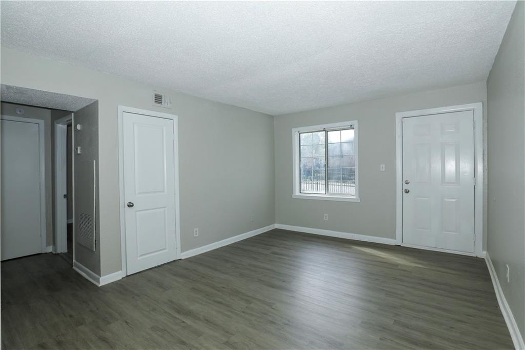2065 Alison Court Southwest, Unit 6 Atlanta, GA 30311 - Photo 3 of 14 a view of an empty room with wooden floor and a window