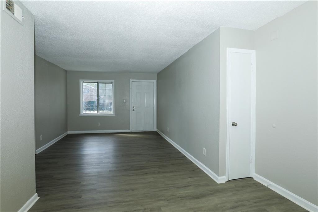 2065 Alison Court Southwest, Unit 6 Atlanta, GA 30311 - Photo 4 of 14 an empty room with wooden floor and windows