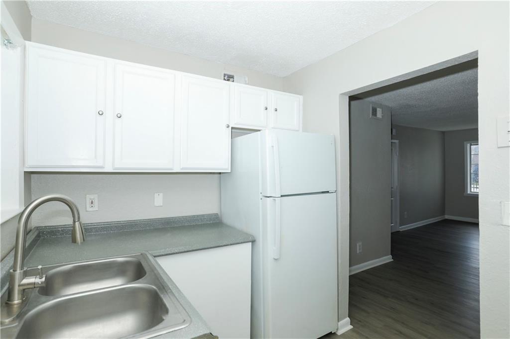 2065 Alison Court Southwest, Unit 6 Atlanta, GA 30311 - Photo 5 of 14 a kitchen with a refrigerator and a sink
