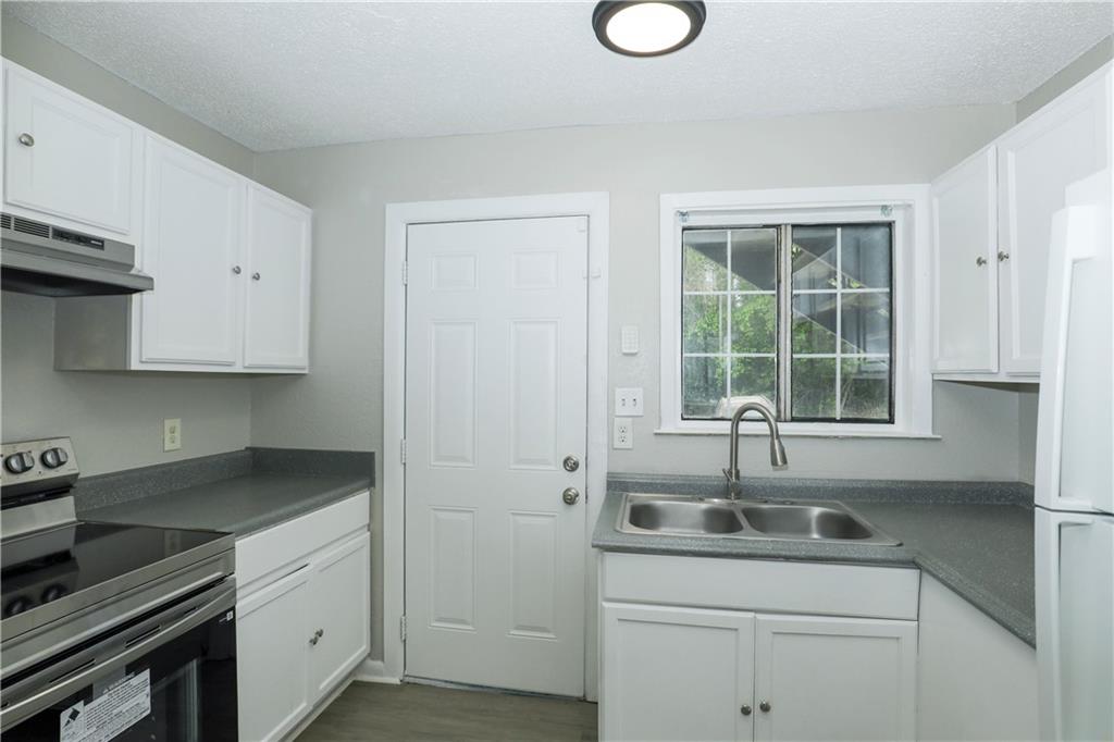 2065 Alison Court Southwest, Unit 6 Atlanta, GA 30311 - Photo 6 of 14 a kitchen with a sink cabinets and window