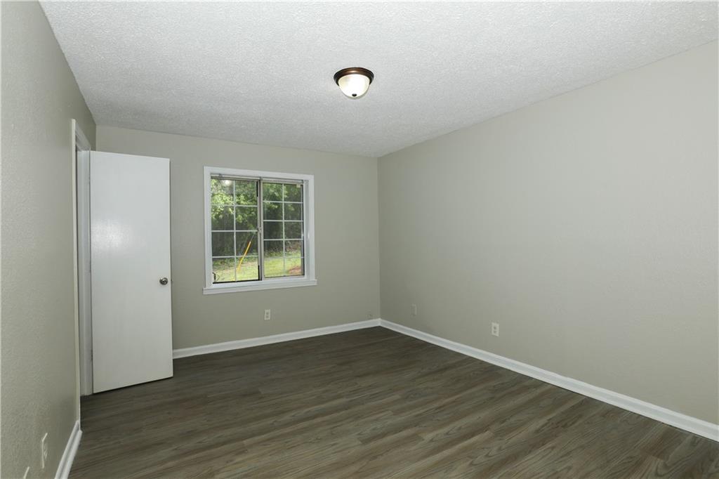 2065 Alison Court Southwest, Unit 6 Atlanta, GA 30311 - Photo 8 of 14 an empty room with wooden floor and windows