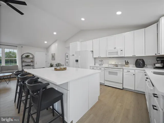 a kitchen that has a lot of cabinets in it with appliances and cabinets