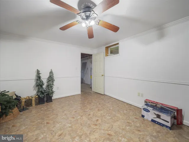 a view of a livingroom with a ceiling fan and hardwood floor