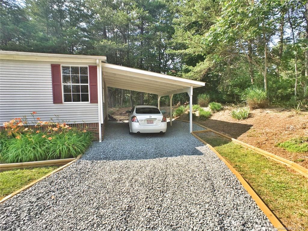 5563 South Wilson Hill Road Mill Spring, NC 28756 - Photo 5 of 18 a car parked in front of a house