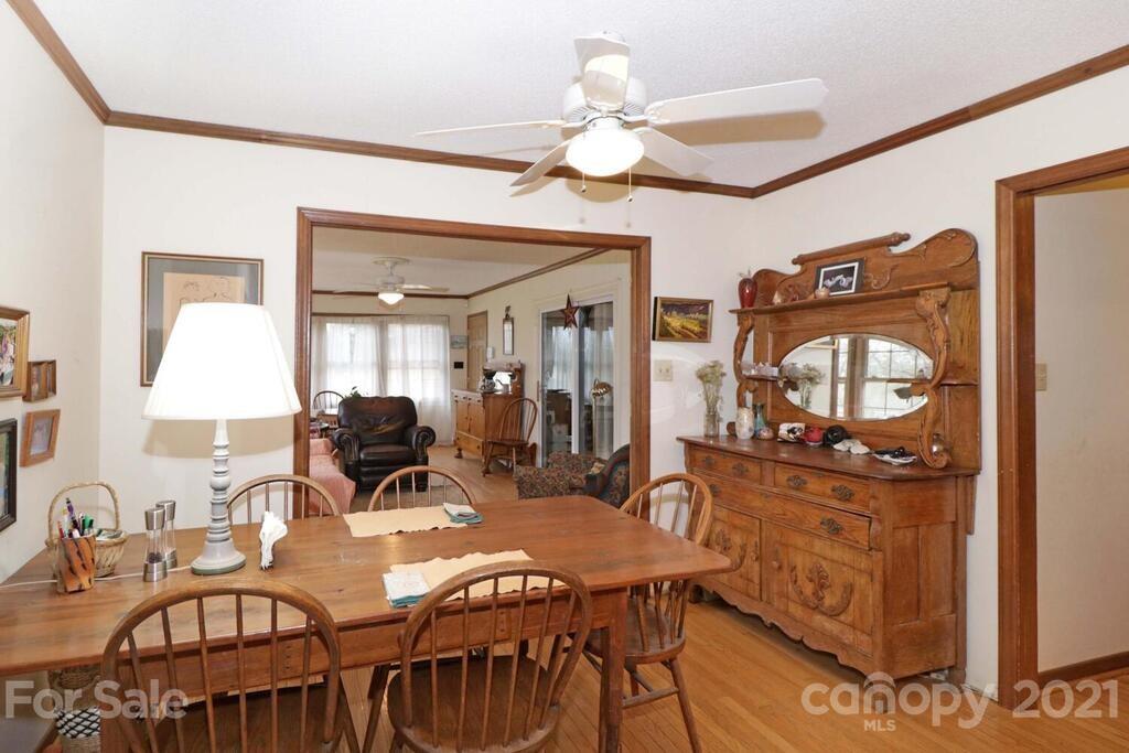 517 Old Pageland Monroe Road Monroe, NC 28112 - Photo 12 of 48 a view of a a dining room with furniture a chandelier and wooden floor
