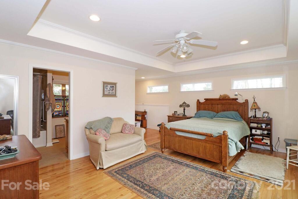 517 Old Pageland Monroe Road Monroe, NC 28112 - Photo 19 of 48 a spacious bedroom with a bed and ceiling fan