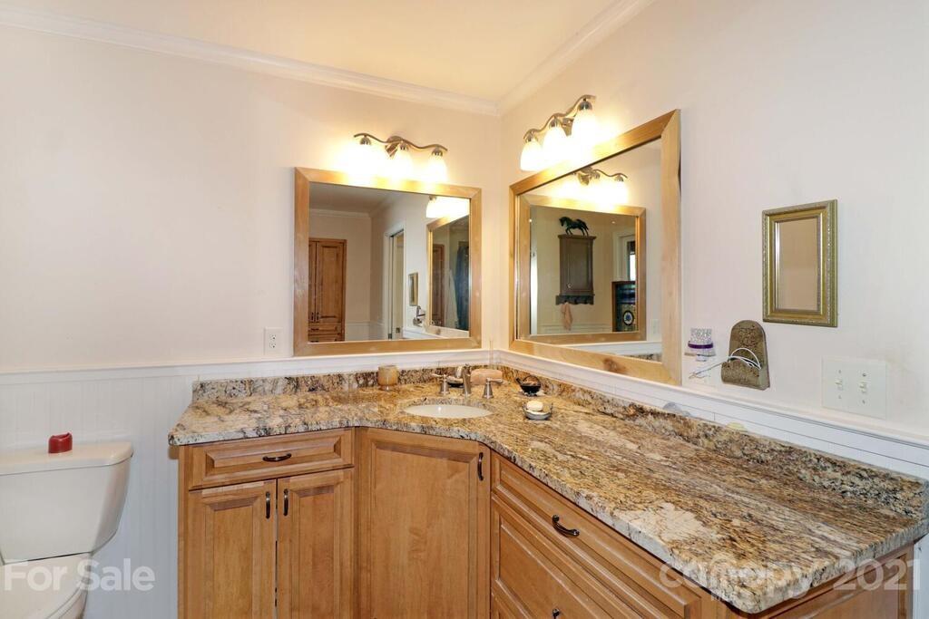 517 Old Pageland Monroe Road Monroe, NC 28112 - Photo 23 of 48 a bathroom with a granite countertop sink and a mirror