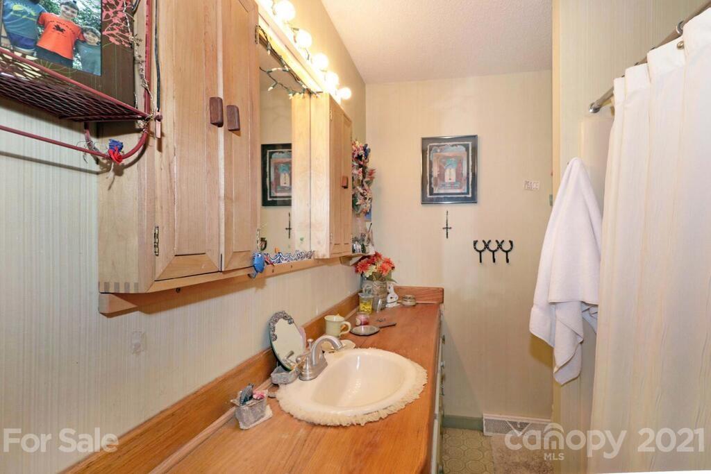 517 Old Pageland Monroe Road Monroe, NC 28112 - Photo 25 of 48 a bathroom with a sink and a mirror
