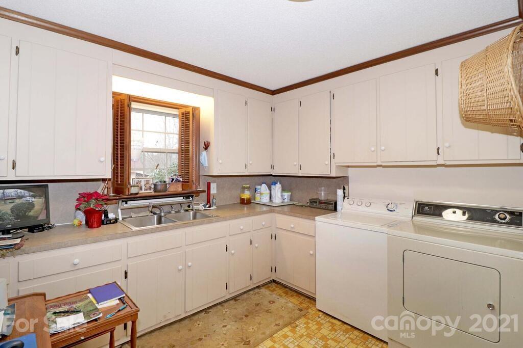 517 Old Pageland Monroe Road Monroe, NC 28112 - Photo 26 of 48 a kitchen with a sink cabinets and utility