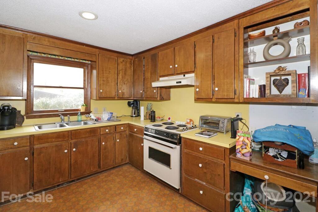 517 Old Pageland Monroe Road Monroe, NC 28112 - Photo 29 of 48 a kitchen with stainless steel appliances granite countertop a stove a sink and a microwave