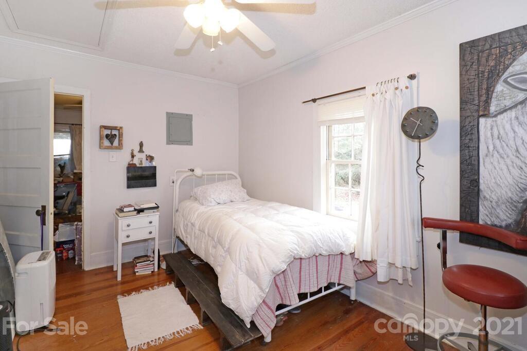 517 Old Pageland Monroe Road Monroe, NC 28112 - Photo 30 of 48 a bedroom with a bed and a chandelier