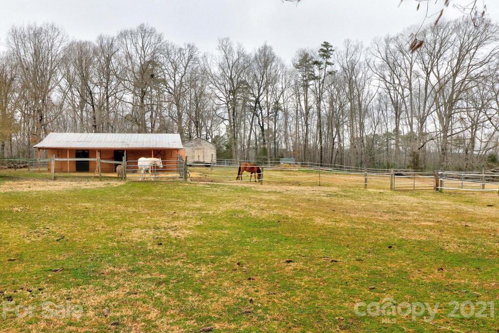 517 Old Pageland Monroe Road Monroe, NC 28112 - Photo 39 of 48 a house view with swimming pool and trees in the background