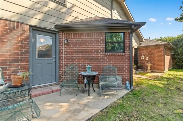 a view of a patio with table and chairs and potted plants