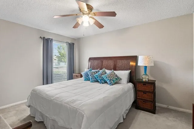 a bedroom with a bed and a ceiling fan