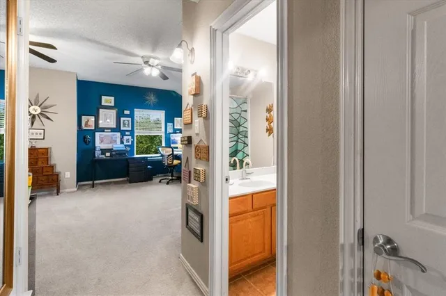 a view of a livingroom with furniture and a ceiling fan