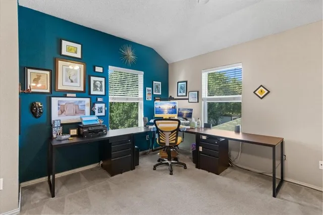 a view of a livingroom with workspace and a window
