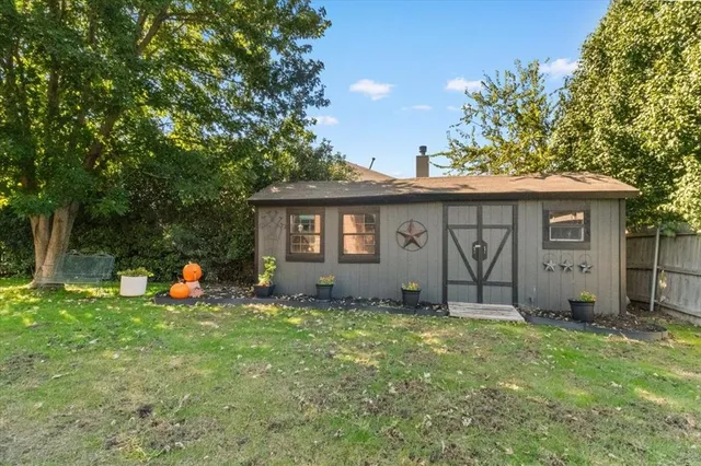 a backyard of a house with table and chairs