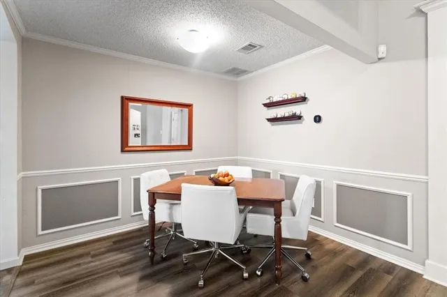 a view of a workspace with furniture and wooden floor