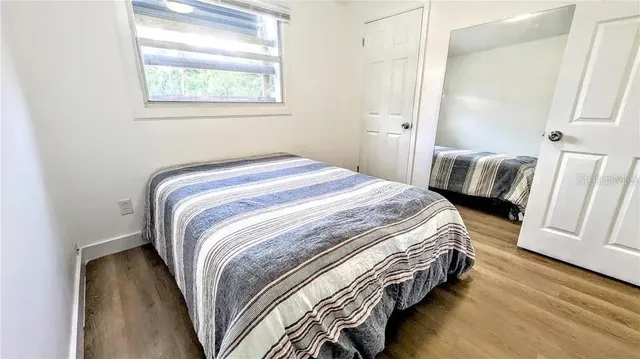 a bedroom with a bed and a window