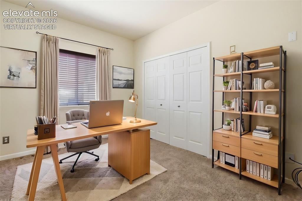 7806 Dutch Loop Colorado Springs, CO 80925 - Photo 17 of 41 a view of a workspace with furniture and a window