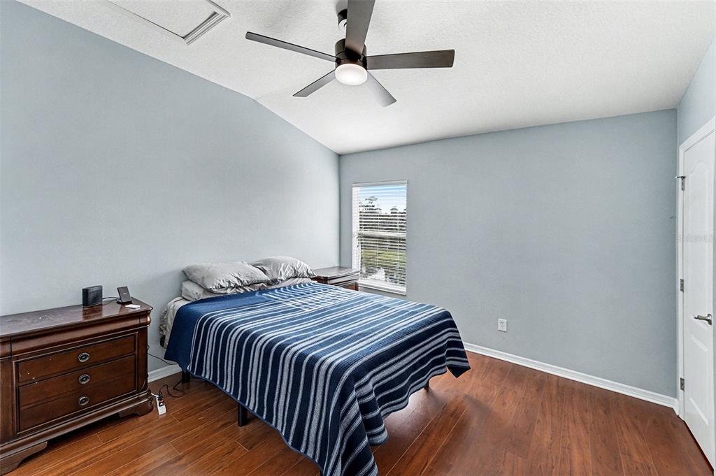 5860 Fishhawk Ridge Drive Lithia, FL 33547 - Photo 11 of 31 a bedroom with a bed and wooden floor