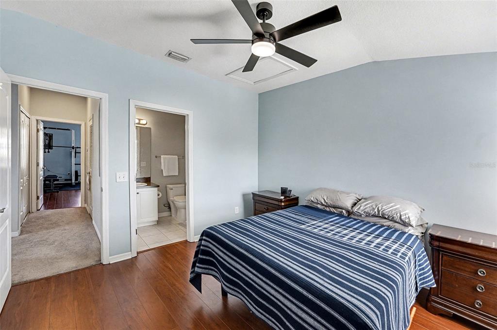 5860 Fishhawk Ridge Drive Lithia, FL 33547 - Photo 12 of 31 a bedroom with bed and a chandelier